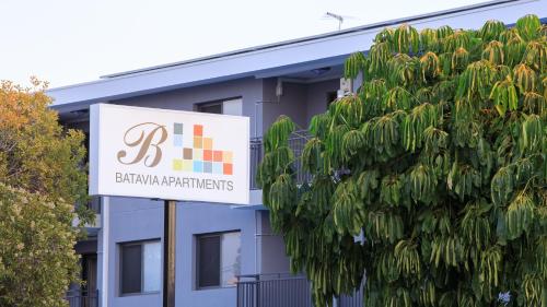 a building with a sign in front of it at Batavia Apartments in Perth