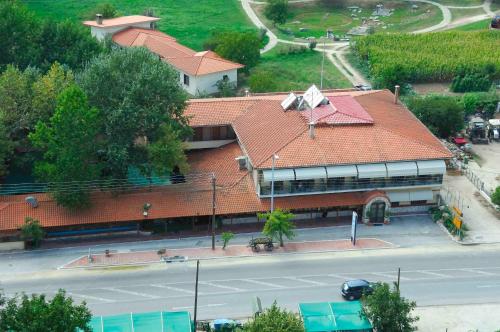a building with a red roof next to a street at Lydia Hotel in Krinídhes