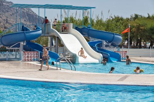 a group of people in the water at a water park at Lindos Princess Beach Hotel in Lardos