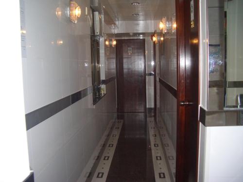 a corridor of a bathroom with a door and a hallway at Sun Shine Guest House in Hong Kong