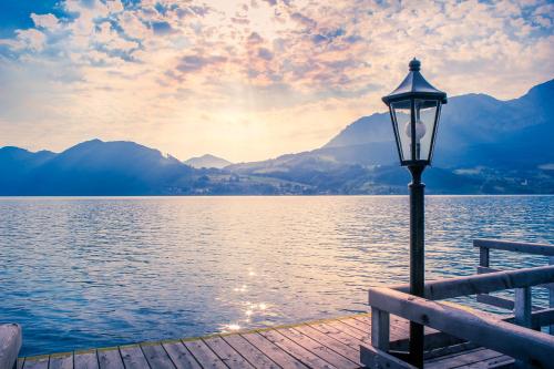 a street light on a dock next to a body of water at Hotel Stadler am Attersee in Unterach am Attersee