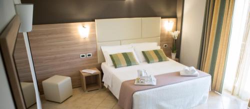 a hotel room with a bed and a table at Hotel Prestige in Montesilvano