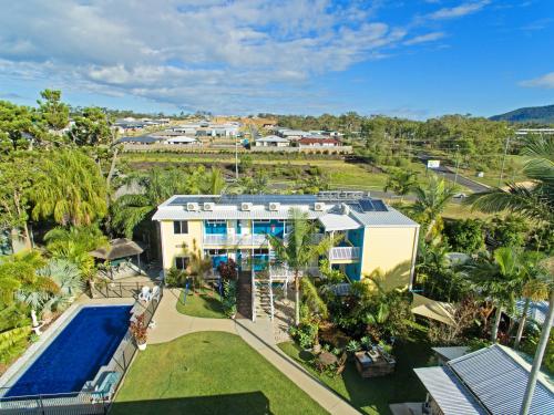an aerial view of a house with a swimming pool at Coral Inn Boutique Motel in Yeppoon