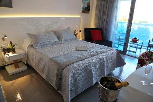 a bedroom with a bed with a laptop on it at TRYP by Wyndham Corfu Dassia in Dassia