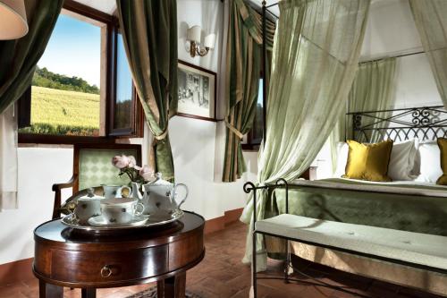 a living room filled with furniture and a window at Relais Osteria Dell'Orcia in Bagno Vignoni