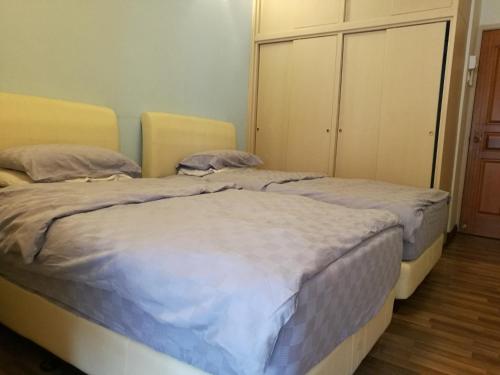 dos camas sentadas una al lado de la otra en un dormitorio en Vistana Residence, Bayan Lepas Penang, en Bayan Lepas