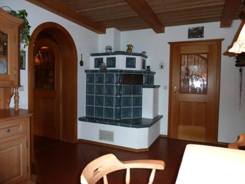 a kitchen with a microwave on top of a stove at Ferienhaus Lerche in Bad Birnbach