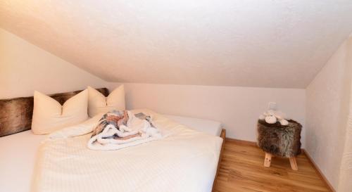 a room with a bed with a stuffed animal on it at Sonn Alpin - Ferienwohnungen in Grän