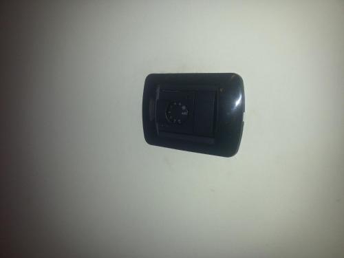 a black lightswitch hanging on a white wall at Residenza Teodolinda in Monza