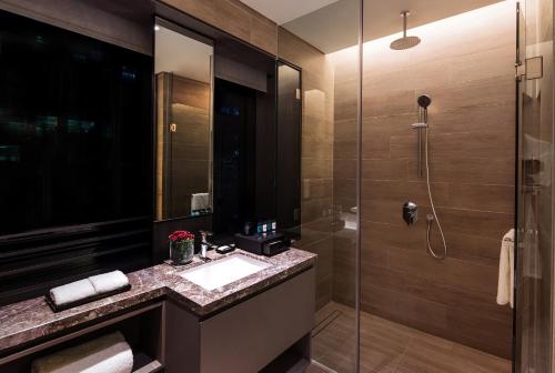 a bathroom with a sink and a shower at Dao by Dorsett AMTD Singapore in Singapore