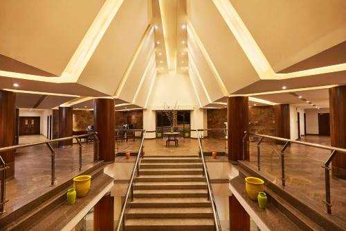 a staircase in a building with a large ceiling at Sterling Mussoorie in Mussoorie
