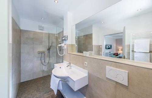 a bathroom with a sink and a shower at Villa Christina in Pörtschach am Wörthersee