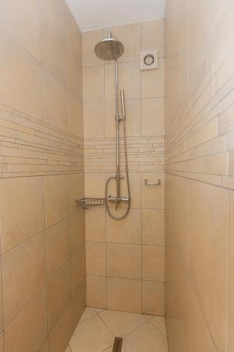a bathroom with a shower with white tiles at Villa Joma 2 in Trogir