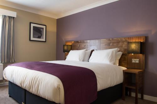 a hotel room with a large bed with white sheets at The Crown & Greyhound by Innkeeper's Collection in London