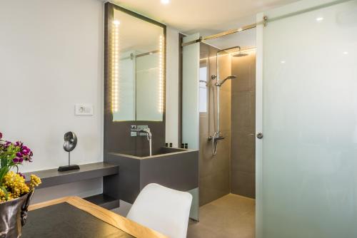 a bathroom with a shower and a sink at Forum Suites in Kato Daratso