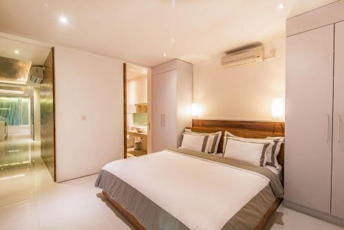 a bedroom with a large bed and a bathroom at Villa Kamag Seminyak in Seminyak
