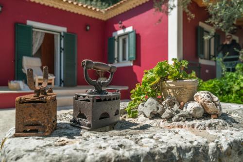 a group of objects sitting on a table in front of a house at Aelia Villa in Kallithea