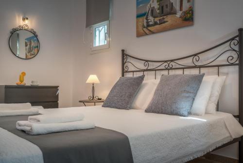 a bedroom with two beds and a mirror at Aelia Villa in Kallithea