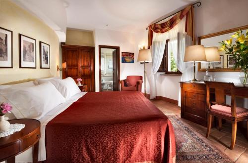 a hotel room with a large bed and a large window at Relais Osteria Dell'Orcia in Bagno Vignoni