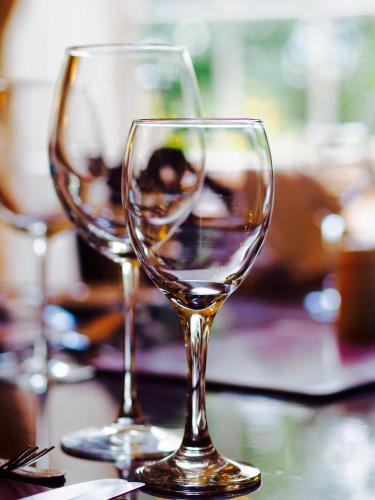 two wine glasses sitting on top of a table at Wrangham House in Filey