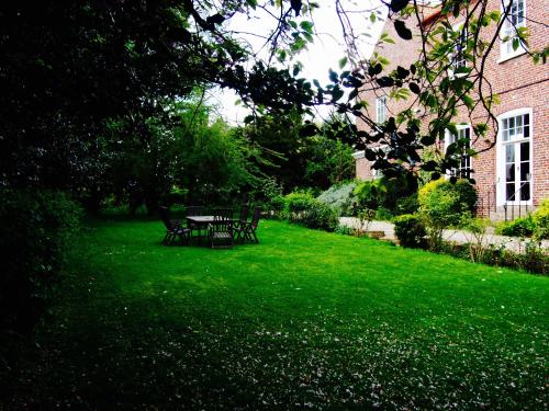 a table and chairs in a yard with green grass at Wrangham House in Filey