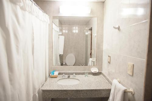 a bathroom with a sink and a mirror at Hotel Princess in Mendoza