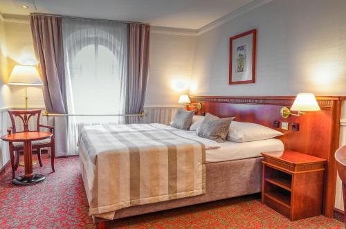 Кровать или кровати в номере Adria Hotel Prague