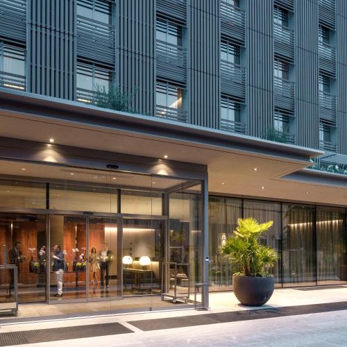 a rendering of a building with large glass windows at Hotel VIU Milan, a Member of Design Hotels in Milan