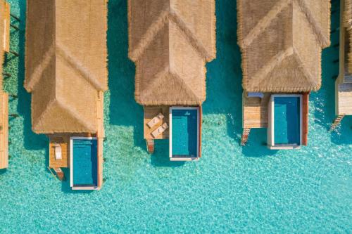 an overhead view of a group of huts in the water at Kudafushi Resort & Spa in Raa Atoll