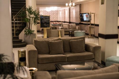 a living room with a couch and a tv at Prince Hotel in Mar del Plata