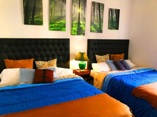 two beds sitting next to each other in a bedroom at BOOKINGHAM ★Apartaments & Suites in Madrid