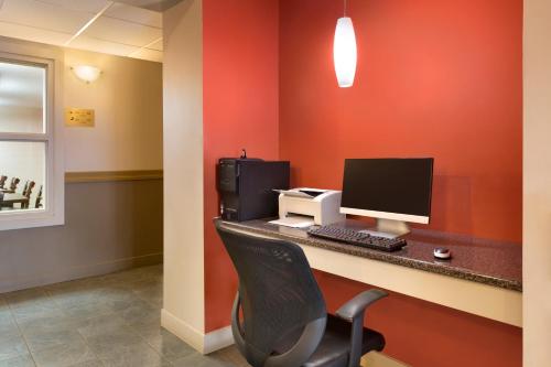 an office with a desk with a computer and a printer at Travelodge by Wyndham Kindersley in Kindersley