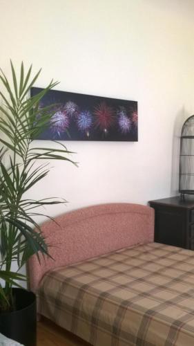 a bedroom with a pink bed and a plant at Home Sweet Home in Rīga