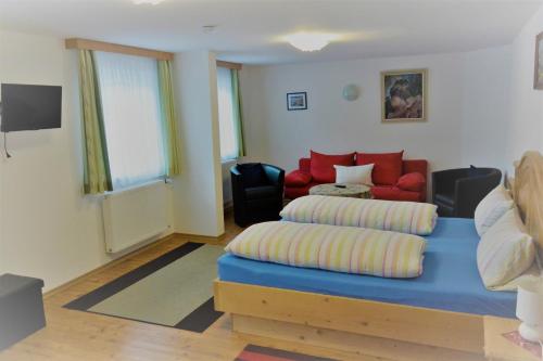 a living room with a couch and a bed at Pension Zillnhäusl in Schönau am Königssee