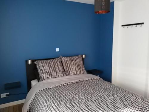 1 dormitorio azul con 1 cama con pared azul en Pause Messines Chez Thérèse, en Verlinghem