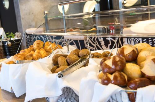 three baskets of pastries on a counter in a bakery at Ibis München Airport Süd in Hallbergmoos