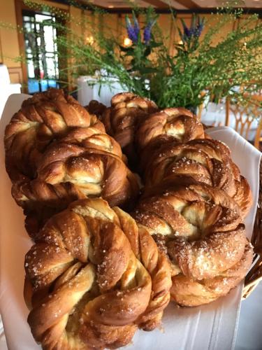 a pile of pastries on a plate on a table at Alver Hotel in Alversund