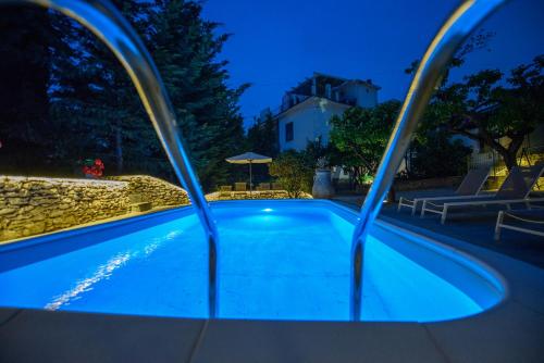 a swimming pool in a backyard at night at Gli Aranci in Agropoli