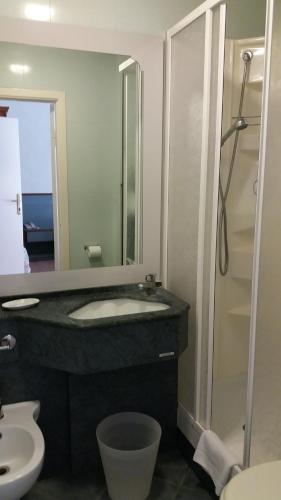 a bathroom with a toilet a sink and a shower at Frank's Hotel in Capoliveri