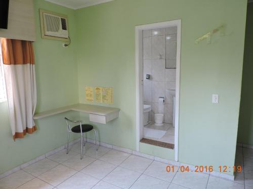 a bathroom with a shower and a sink and a toilet at Hotel Brooklin in Sao Paulo