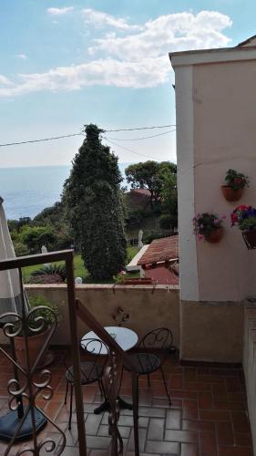 a balcony with chairs and a view of the ocean at B&B La Torretta in Maratea