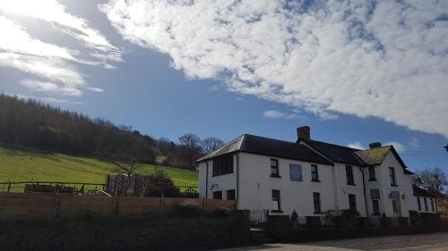 a white house sitting on the side of a road at The Kestrel B&B in Crickhowell