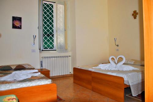 A bed or beds in a room at Casa per Ferie Beato Rosaz