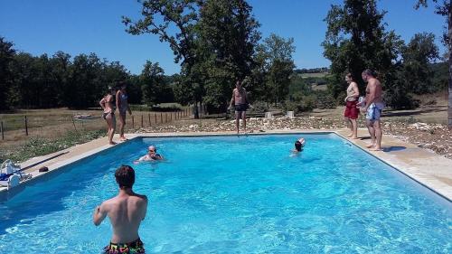 a group of people standing in a swimming pool at AUBERGE LE GABACHOU in Montpezat-de-Quercy