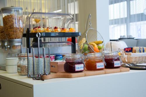 a counter with jars of food on a counter top at Hotel Kristoffel in Middelkerke