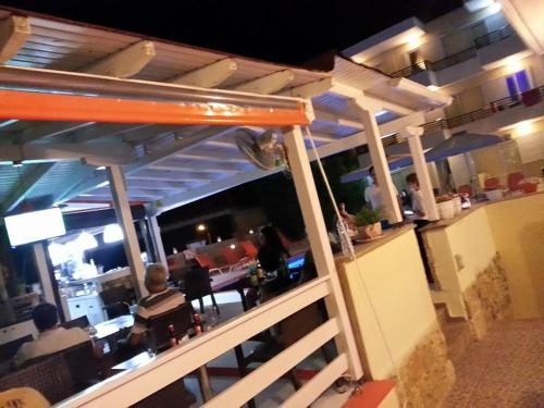 a restaurant with people sitting at a bar at Maya Bay in Kallithea Halkidikis