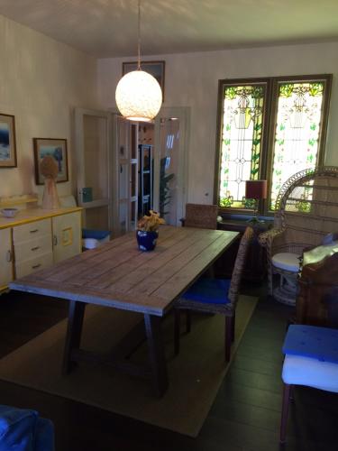 a dining room with a wooden table and chairs at Bruseschi in Grado