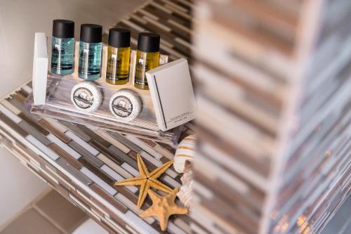a shelf with bottles of essential oils and a starfish at Kokona in Symi