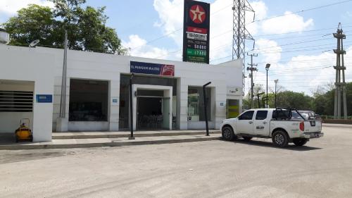 a white truck parked in front of a gas station at Hotel las Olas Malambo in Malambo