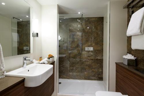 a bathroom with a sink and a shower at Sir Christopher Wren Hotel in Windsor